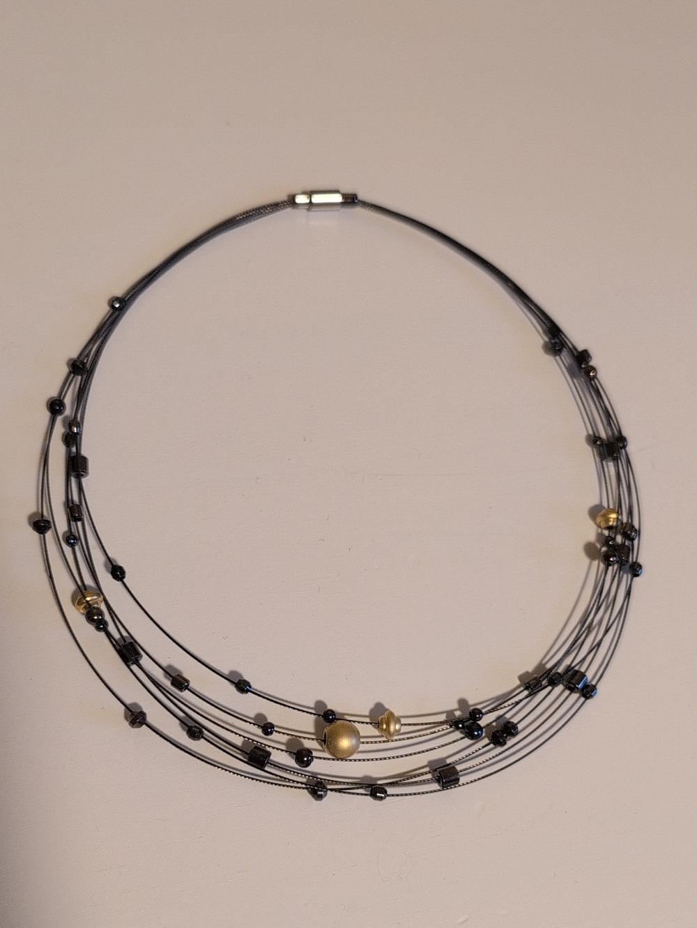 Multi-Strand Black Wire Necklace with Gold Accent Beads